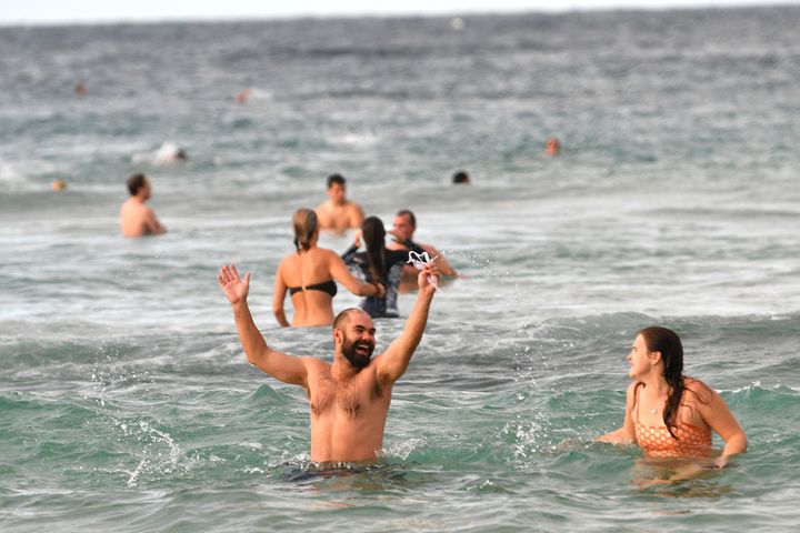 Beachgoers enjoy their first swim after Bondi Beach reopened following a five week closure in Sydney on April 28, 2020, amid the novel coronavirus pandemic. (Photo by SAEED KHAN/AFP via Getty Images)