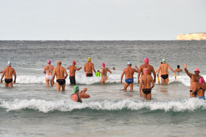 Beachgoers enjoy their first swim after Bondi Beach reopened following a five week closure in Sydney on April 28, 2020 (Photo by SAEED KHAN/AFP via Getty Images)