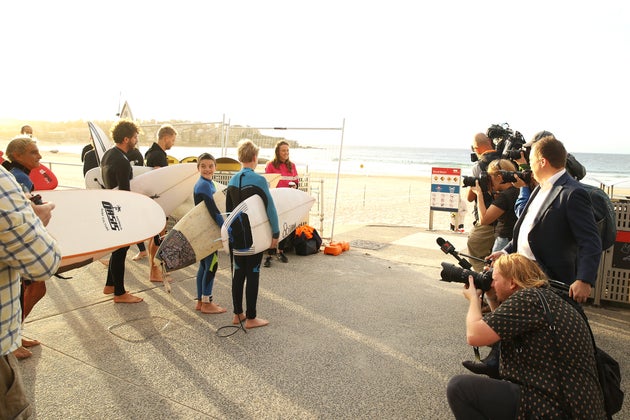 SYDNEY, AUSTRALIA - APRIL 28: The media capture surfers waiting for the 7am reopening of Bondi beach on April 28, 2020 in Sydney, Australia. Waverley Council reopened Bondi, Bronte and Tamarama beaches today, with COVID-19 social distancing rules still in place. The beaches will be open from 7am to 5pm for swimmers and surfers on weekdays, but will remain closed on weekends. Several beaches in Sydney's Eastern suburbs were closed March 28, after large crowds were seen gathering at Bondi Beach despite social distancing orders in place to slow the spread of COVID-19. (Photo by Mark Kolbe/Getty Images)