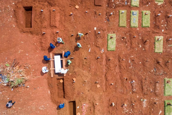 Aerial picture of municipality workers burying a coronavirus disease (COVID-19) victim at a grave complex provided by the gov