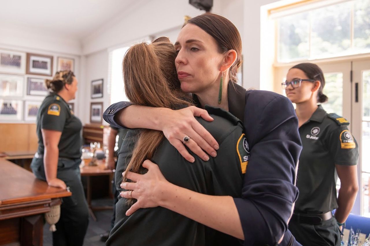 Jacinda Ardern hugs a first responder in Whakatane, New Zealand, the day after a volcanic island in New Zealand erupted on Dec. 9, 2019. 