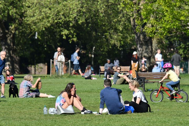 People enjoy the spring sunshine in London Fields park in east London on April 25.