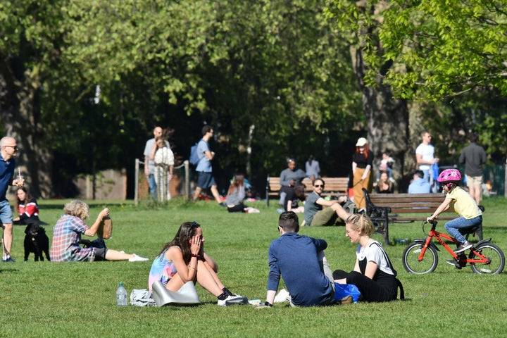 People enjoy the spring sunshine in London Fields park in east London on April 25.