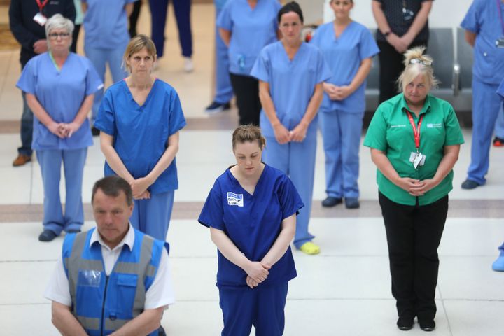 NHS staff at the Mater hospital in Belfast, during a minute's silence to pay tribute to the NHS staff and key workers who have died during the coronavirus outbreak
