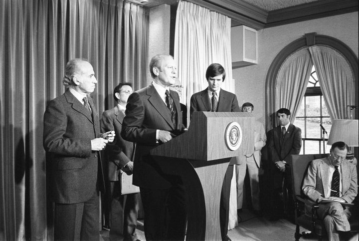 Ford announces the national swine flu immunization program in the White House press briefing room on March 24, 1976. Also shown are polio vaccine pioneers Jonas Salk (left) and Albert Sabin (right) and the secretary of health, education and welfare, David Mathews (far right).