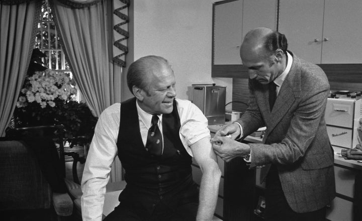 President Gerald Ford receives a swine flu vaccine from his White House physician, William Lukash, on Oct. 14, 1976.