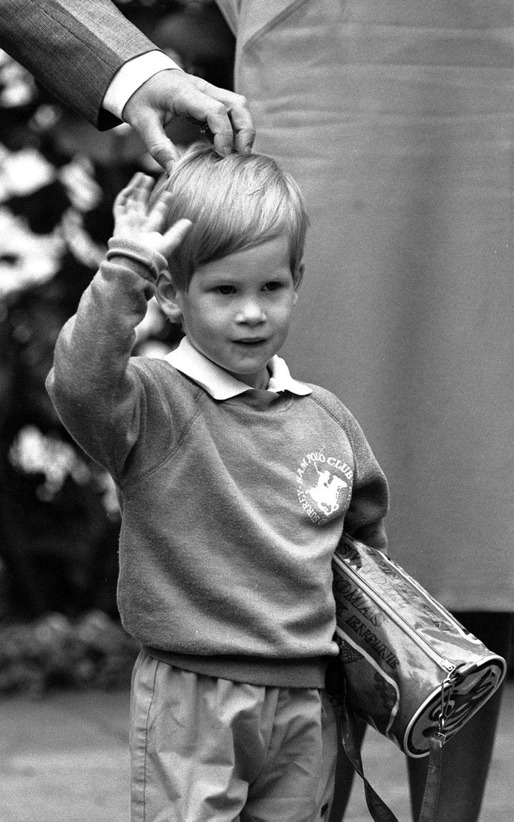 Prince Harry, then 3 years old, arrives for his first day of nursery school at Chepstow Villas in West London with a Thomas t