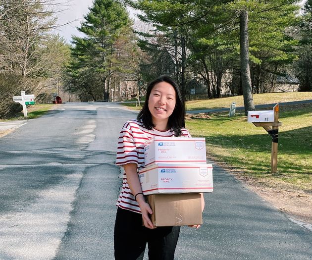 Rine (pictured) and Amy celebrate shipping their second batch of donated items to essential workers two weeks after launching their Give Essential platform.