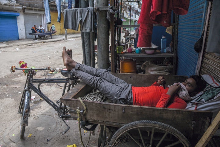 A migrant labour resting in a cycle cart in a lane in Sadar Bazar, during lockdown, on April 25, 2020 in New Delhi, India. 