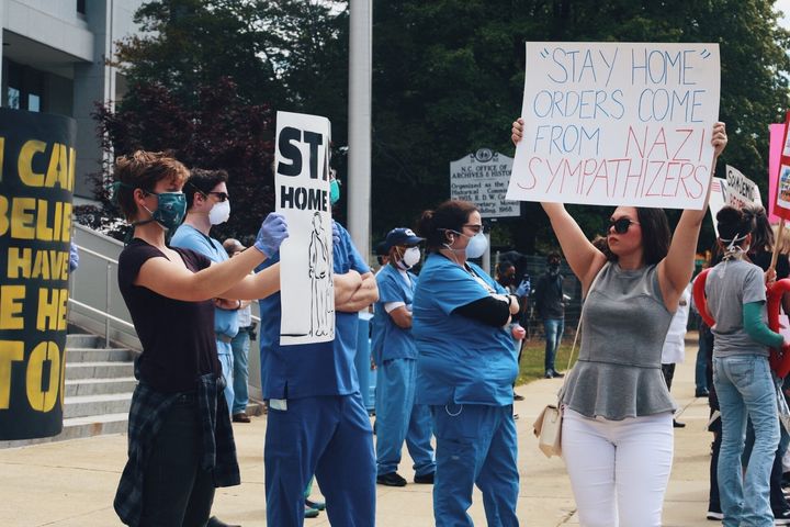 Health care workers staging a counterprotest at the ReOpen NC rally on Tuesday. 