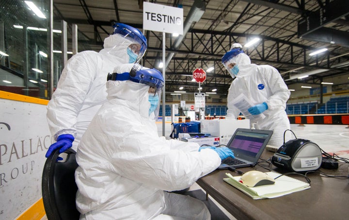 A medical worker inputs testing information at a drive-thru COVID-19 testing centre in Hamilton, Ont., on April 23, 2020.