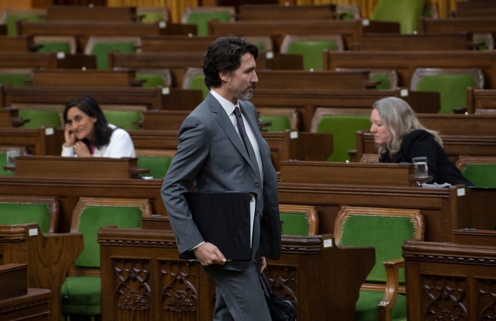 Prime Minister Justin Trudeau makes his way to his seat for a COVID-19 committee meeting in the House of Commons chamber on April 29, 2020 in Ottawa.