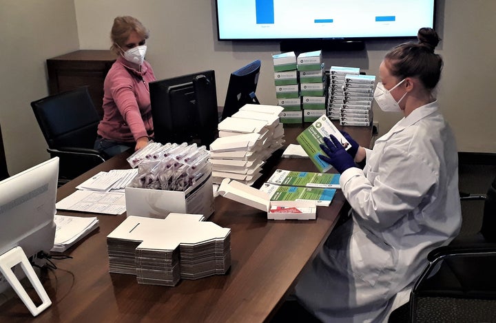 Employees assembling Better2Know's Covid-19 home test kits