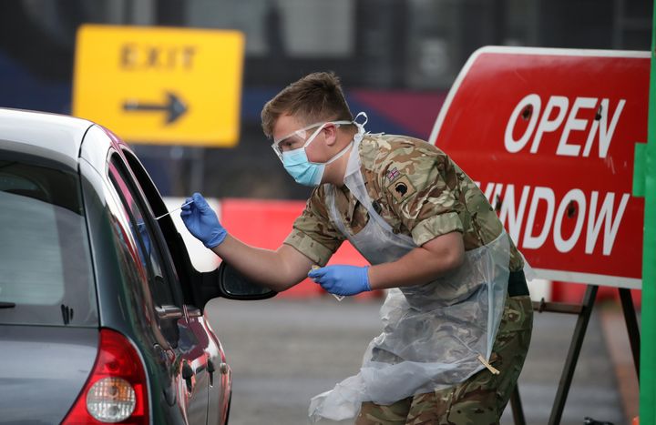 A soldier from 2 Scots Royal Regiment of Scotland assists at a Covid-19 testing centre at Glasgow Airport, as the UK continues in lockdown to help curb the spread of the coronavirus.