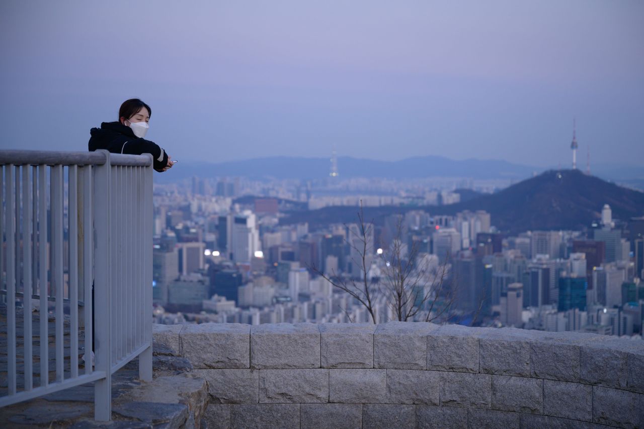 A woman wearing a face mask in Seoul in March 2020.