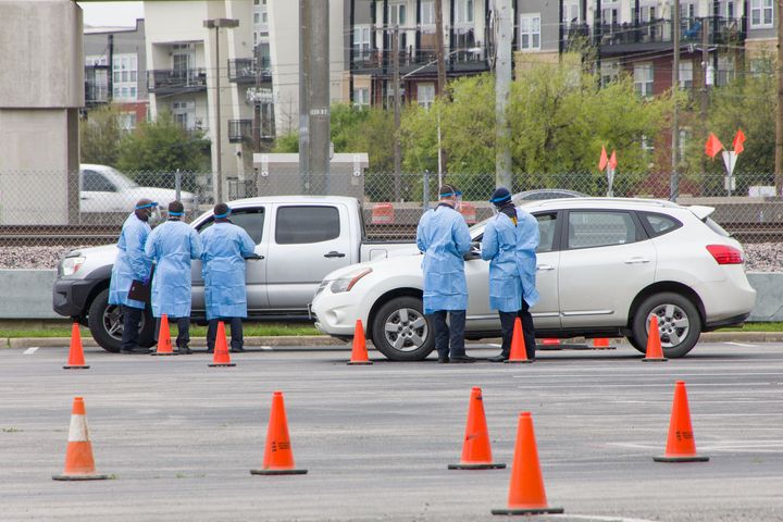 Staff work at a drive-thru COVID-19 testing site in Dallas, March 21.