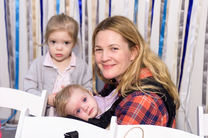 Drew Barrymore and her daughters at the Baby2Baby Holiday Party presented By The Honest Company on December 13, 2014, in Los Angeles.