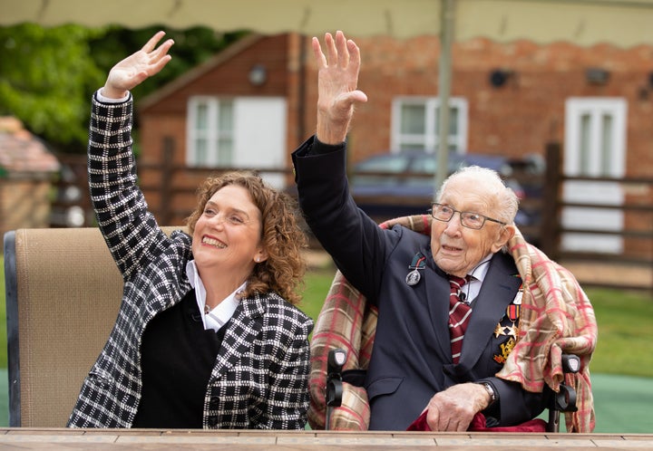 Col. Tom Moore and his daughter Hannah look up as Royal Air Force planes fly over his home on Thursday in Marston Moretaine, England.