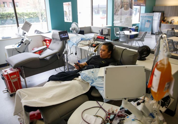 Melissa Cruz, an emergency room technician who recovered from COVID-19, donates convalescent plasma at a blood center in Seattle. 