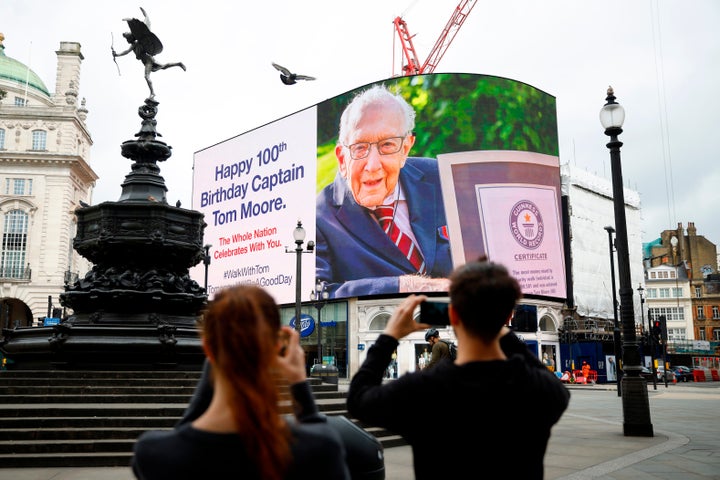 A birthday message for Tom Moore is displayed at Piccadilly Circus in London on Thursday. He turned 100 years old.