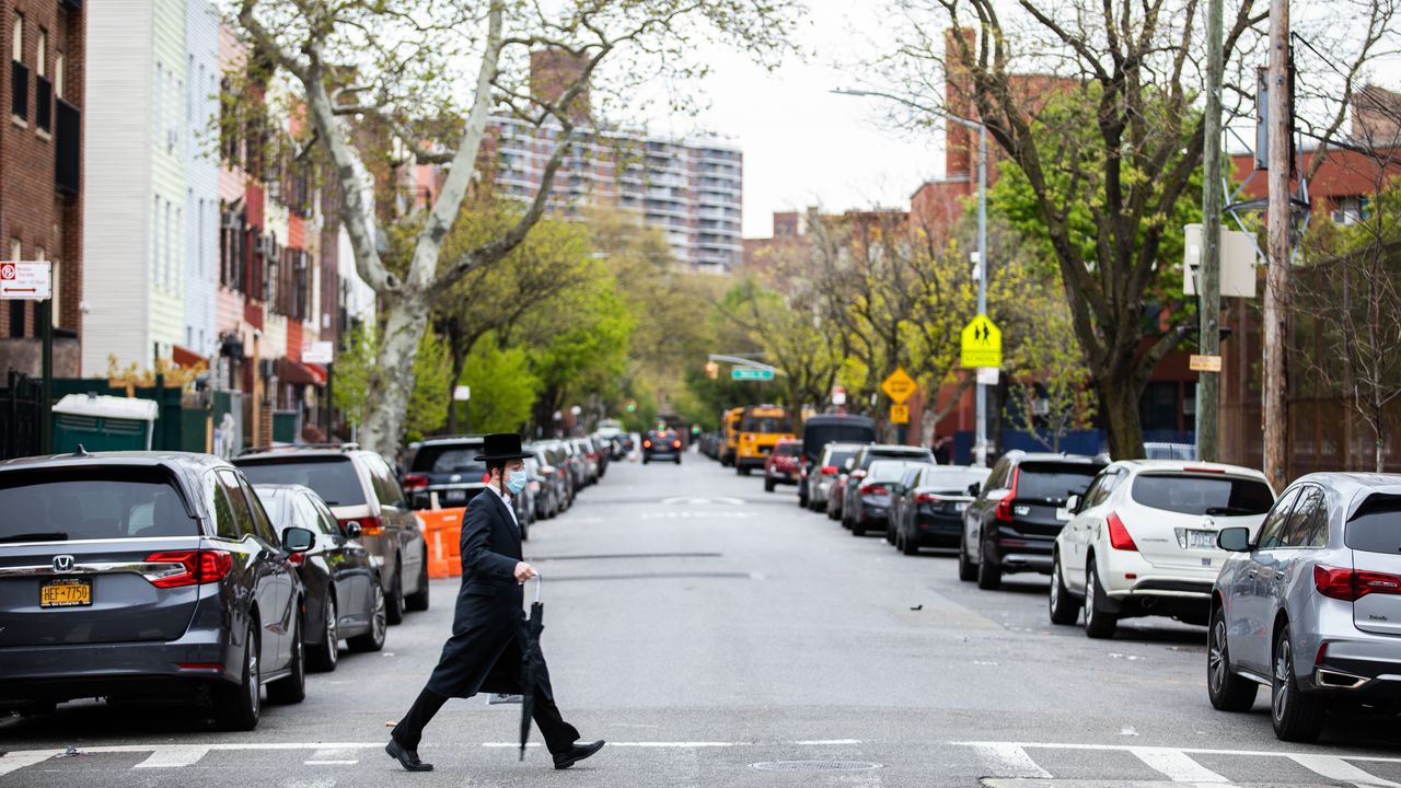 A man crosses the street in the Williamsburg neighborhood of Brooklyn, New York, on April 29.