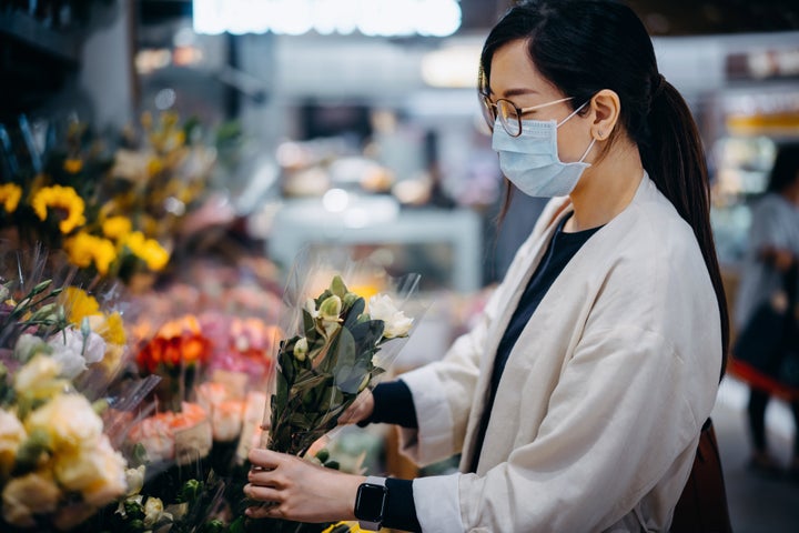 If you live in the same town as your mom, you may consider buying flowers at a grocery store or farmers market and dropping them off yourself.