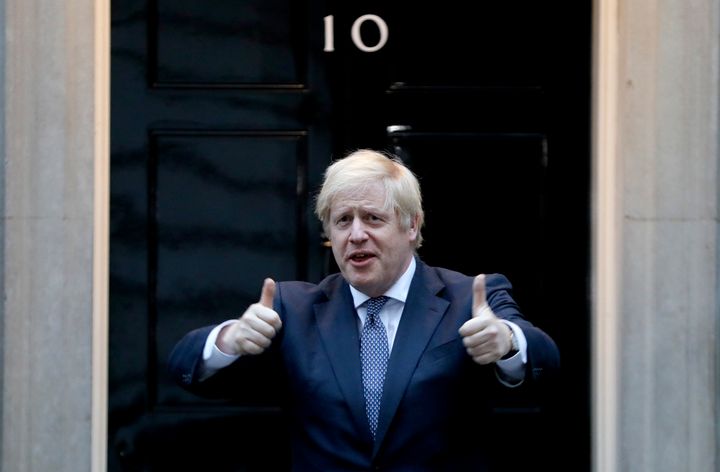 Boris Johnson shows thumbs up before he applauds on the doorstep of 10 Downing Street in London during the weekly Clap for our Carers.