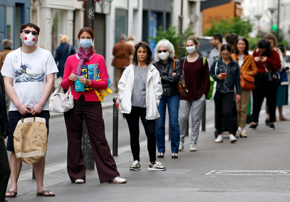 Customers queue in front of a Monoprix supermarket in Paris on April 28.