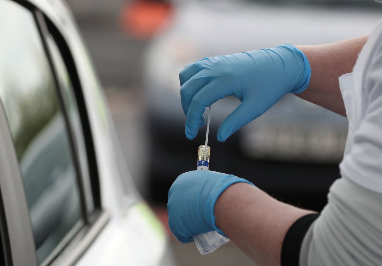 A test sample is held at a Covid-19 testing centre at Glasgow Airport