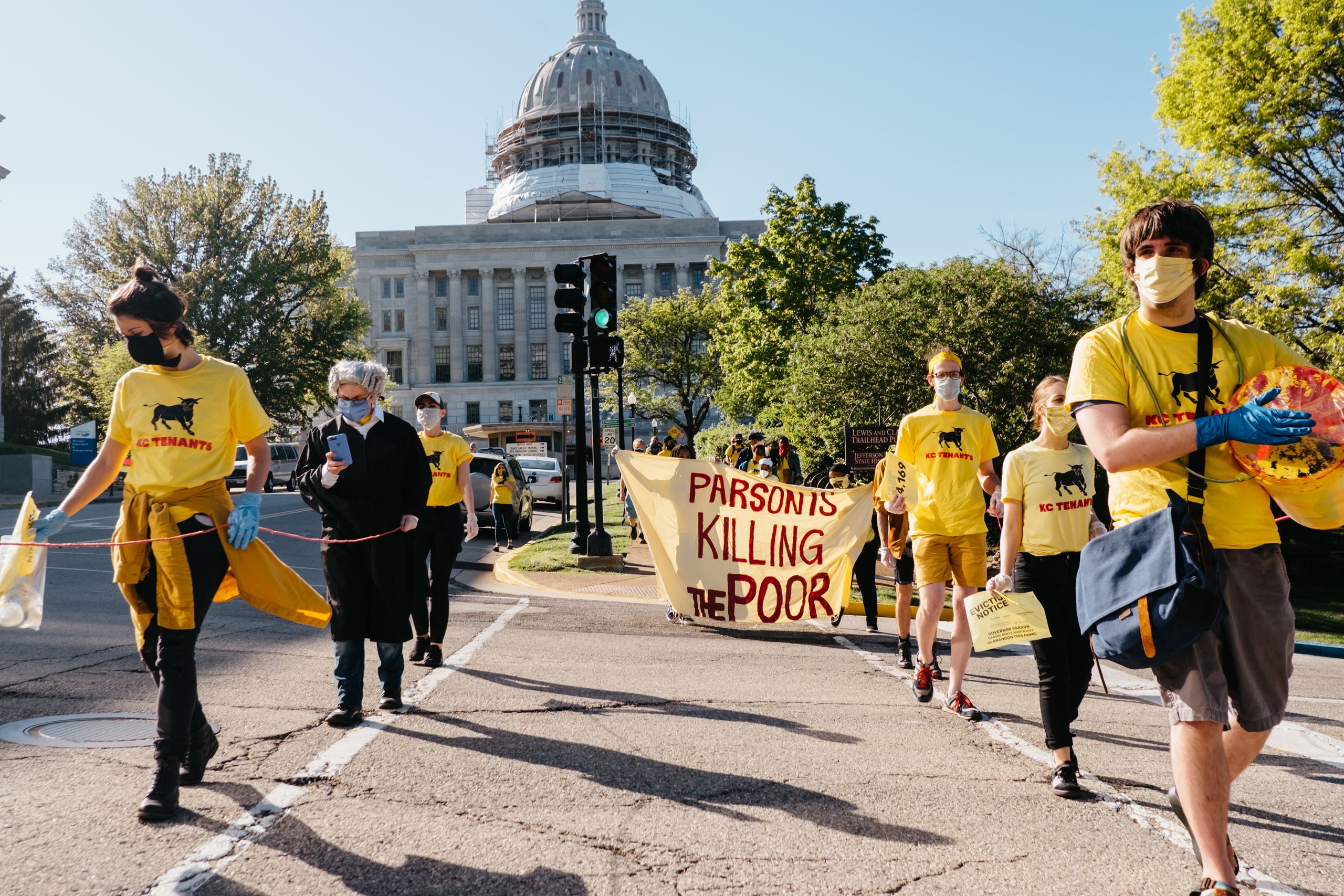 Cancel Rent protesters march from the Missouri state Capitol to the Governor's Mansion to place an eviction notice on the fro