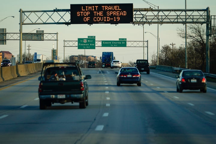 A highway sign on Interstate 75 advises travelers to limit travel in order to slow the spread of the novel coronavirus (COVID-19), taken through a vehicle window, in Cincinnati, Ohio, U.S. March 17, 2020. REUTERS/Bryan Woolston