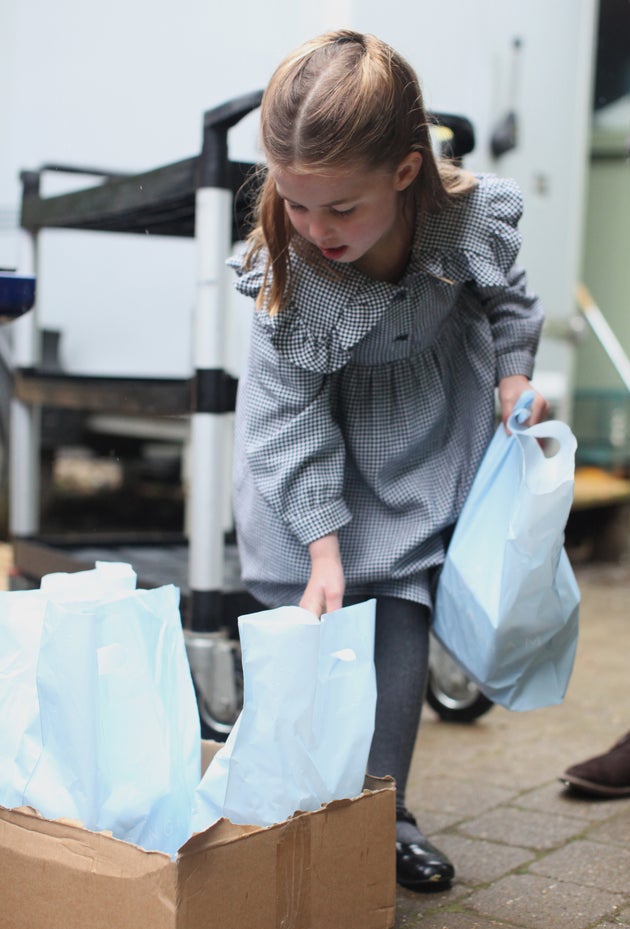 Princess Charlotte, who celebrates her fifth birthday on Saturday, helps to pack up and deliver food packages for isolated pensioners.