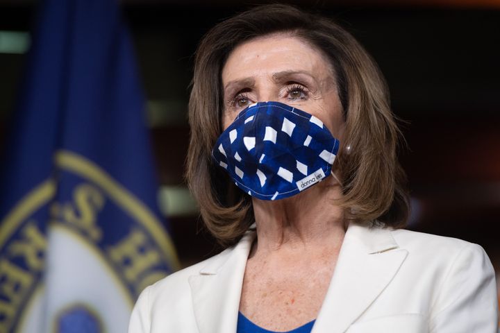 Speaker Nancy Pelosi wears a mask to protect herself and others from COVID-19 at her weekly press conference.