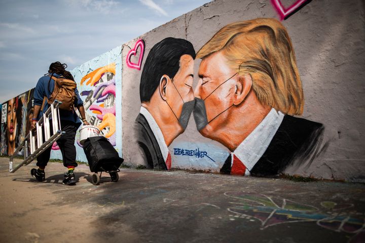 BERLIN, GERMANY - APRIL 28: A graffiti shows Donald Trump, President of the United States of America, and Xi Jinping, President of People's Republic of China, with face masks on April 28, 2020 in Berlin, Germany. (Photo by Florian Gaertner/Photothek via Getty Images)
