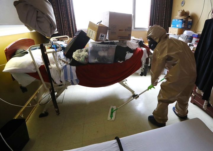 A member of Georgia's National Guard cleans and sanitizes a nursing home room. Some states are using troops to help with infection control and staff shortages.