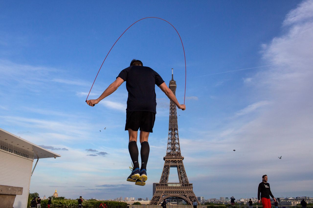 A man exercises along Trocadero Square, close to the Eiffel Tower, Saturday.