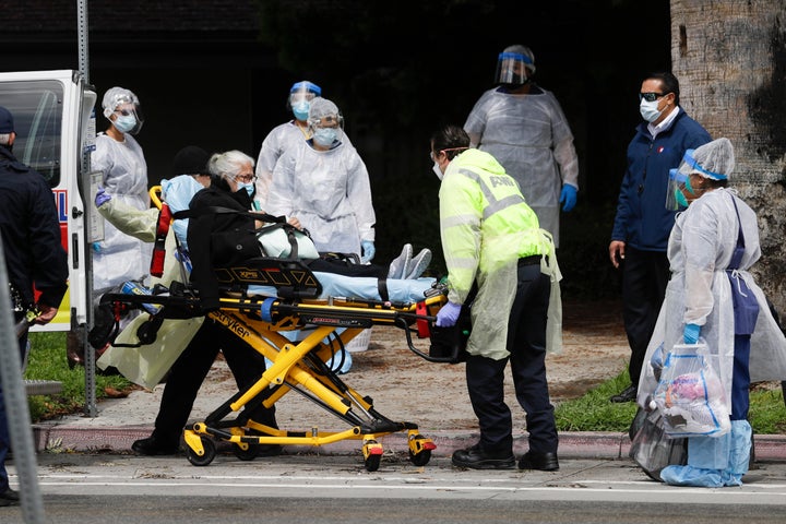A patient is evacuated from the Magnolia Rehabilitation and Nursing Center in Riverside, Calif., Wednesday, April 8, 2020. (A
