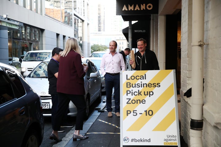 Customers wait for their coffee, bread and pastries outside Amano Bakery on April 29, 2020 in Auckland, New Zealand. With COVID-19 lockdown measures easing slightly, restaurants and other food providers are adapting their operations to be able to trade again. (Photo by Fiona Goodall/Getty Images)