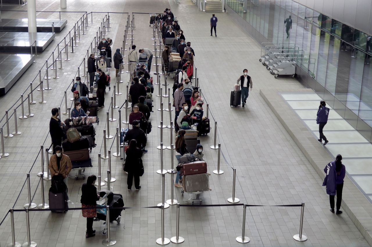 People queue outside the departures area at Heathrow on Friday, May 1.