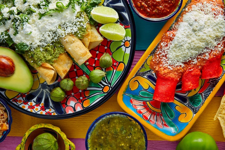 Green and red enchiladas with Mexican sauces.