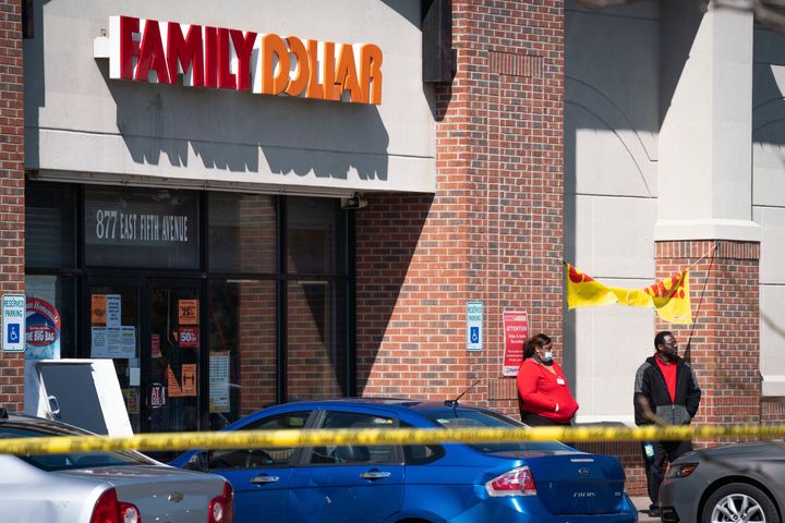 Employees stand outside the Family Dollar store in Flint, Michigan, where a security guard was killed on Friday.