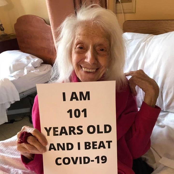 Angelina Friedman holds up a sign at her nursing home.