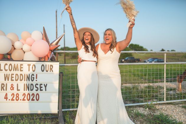 The couple welcome guests to their wedding at Doc’s Drive In Theatre in Buda, Texas.