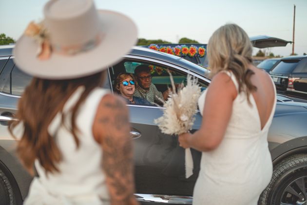 The couple greeted car-bound guests.