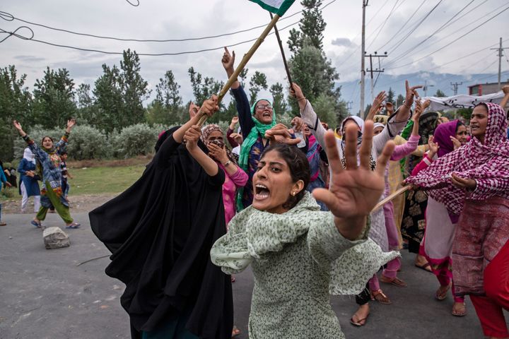 Women shout slogans as policemen fire teargas and live ammunition in the air to stop a protest march in Srinagar, Aug. 9, 2019. The image was part of a series of photographs by Associated Press photographers which won the 2020 Pulitzer Prize for Feature Photography. (AP Photo/Dar Yasin)