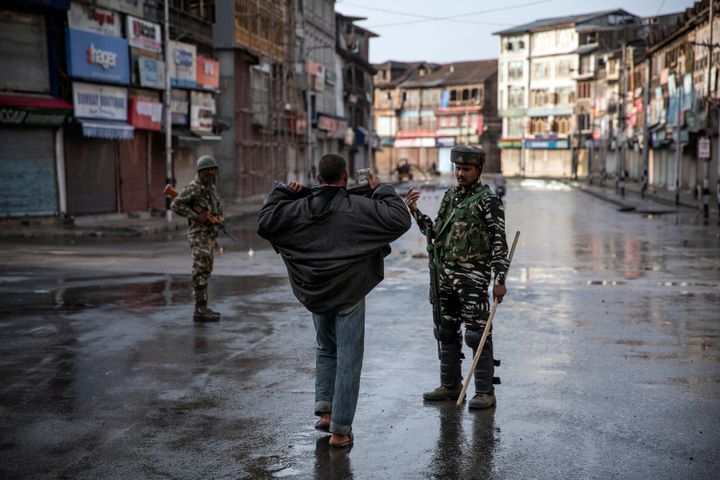 An paramilitary soldier orders a Kashmiri to open his jacket before frisking him during curfew in Srinagar, Aug. 8, 2019. The image was part of a series of photographs by Associated Press photographers which won the 2020 Pulitzer Prize for Feature Photography. (AP Photo/Dar Yasin)