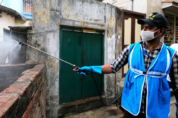 A Howrah Municipal Corporation worker sanitises a Covid-19 hot spot area with disinfectants. 