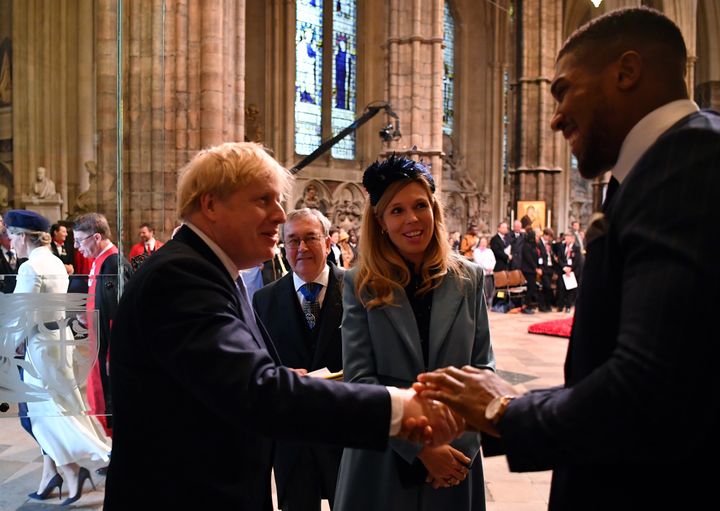 Boris Johnson shakes hands with boxer Anthony Joshua at the annual Commonwealth Service at Westminster Abbey