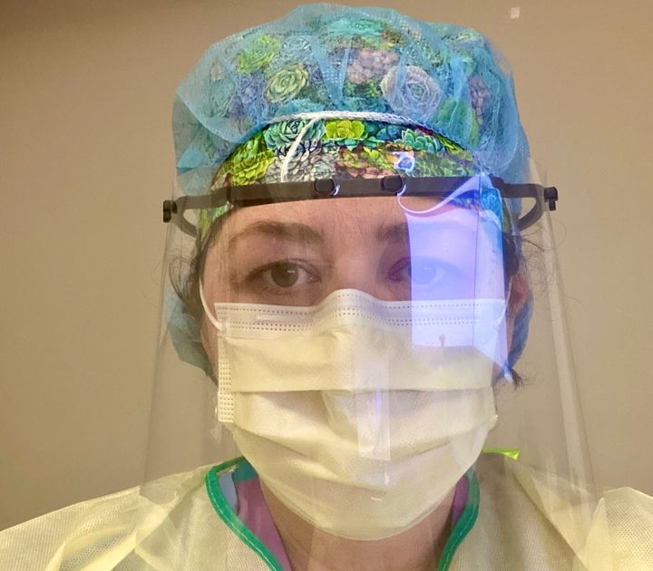 Toronto midwife Christie Lockhart wears personal protective equipment during a 24-hour hospital shift where she attended six births during the COVID-19 crisis.