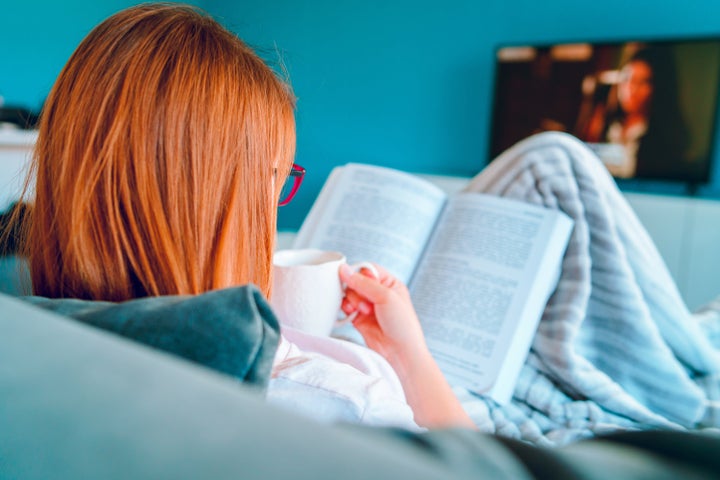 Reading a book, coffee in hand, with the TV on in the background is the perfect way to pass time during a pandemic.